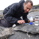 Steve Brusatte investigating dinosaur footprints at the Isle of Skye in Scotland.
